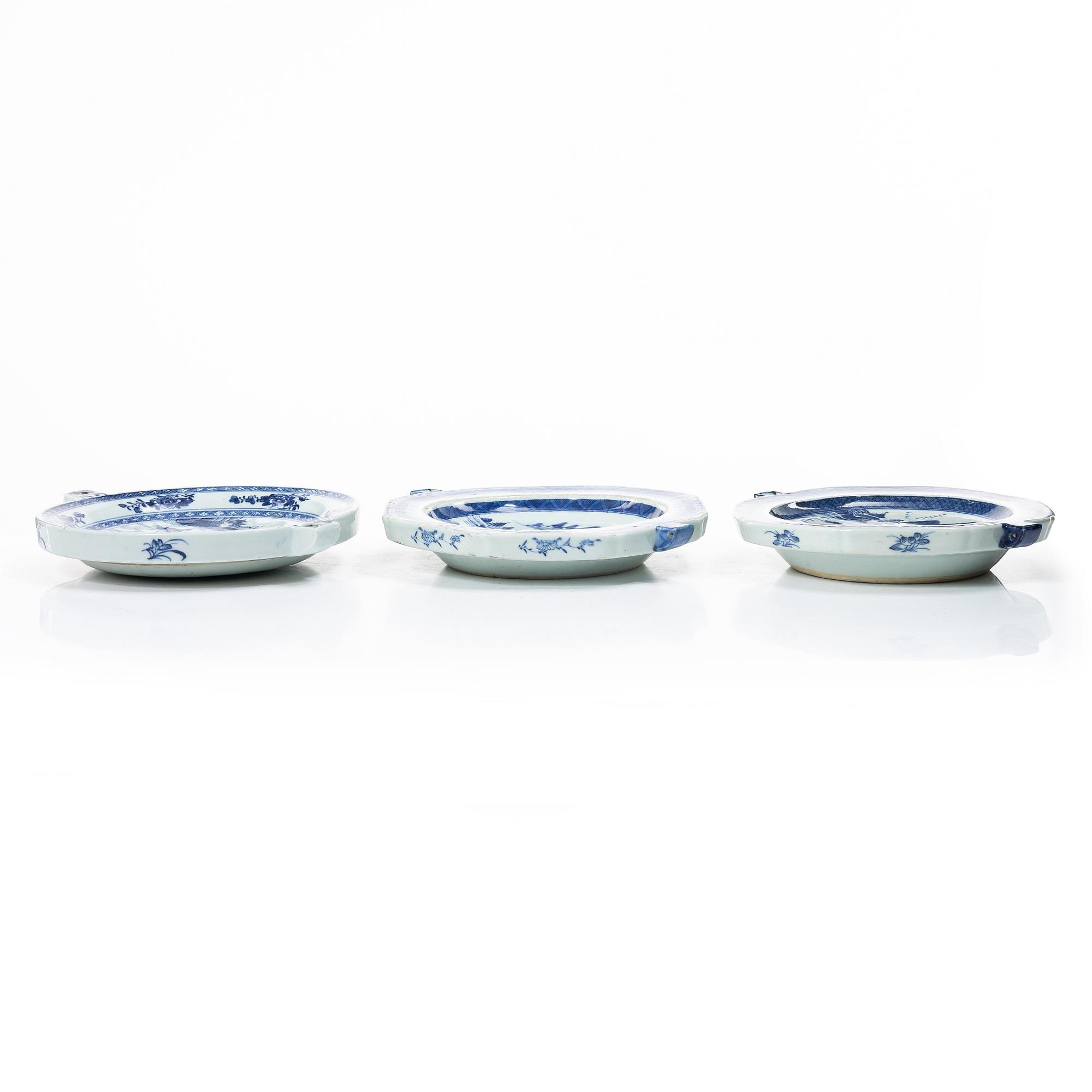 A group of three Chinese blue and white porcelain hot water dishes, Qing dynasty, 18/19th century.