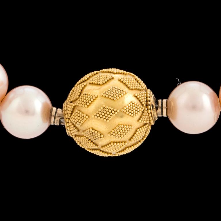 A pearl necklace with an 18K gold clasp by Gaudy according to information given.
