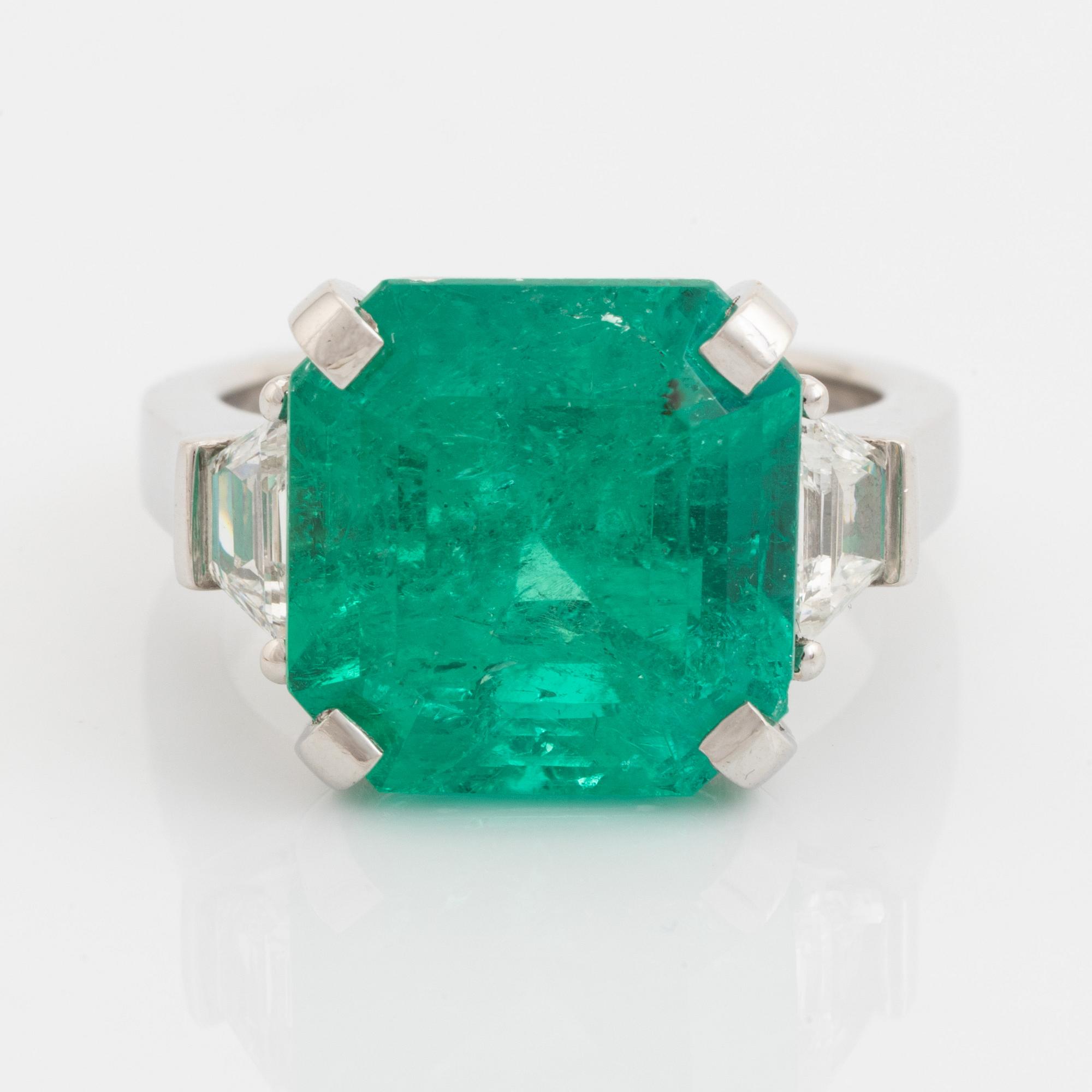 Emerald and trapezoid cut diamond ring.