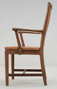 A Carl-Axel Acking walnut armchair, upholstered in light brown leather, Nordiska Kompaniet, Sweden, ca 1947.