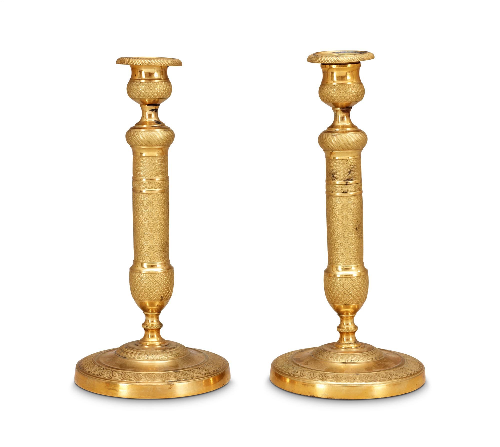 A pair of French Empire early 19th Century candlesticks.