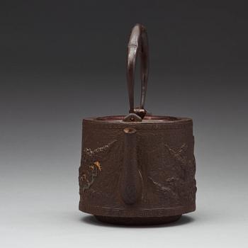 A Japanese iron and bronze tea pot with cover, Meiji period 1868-1912).