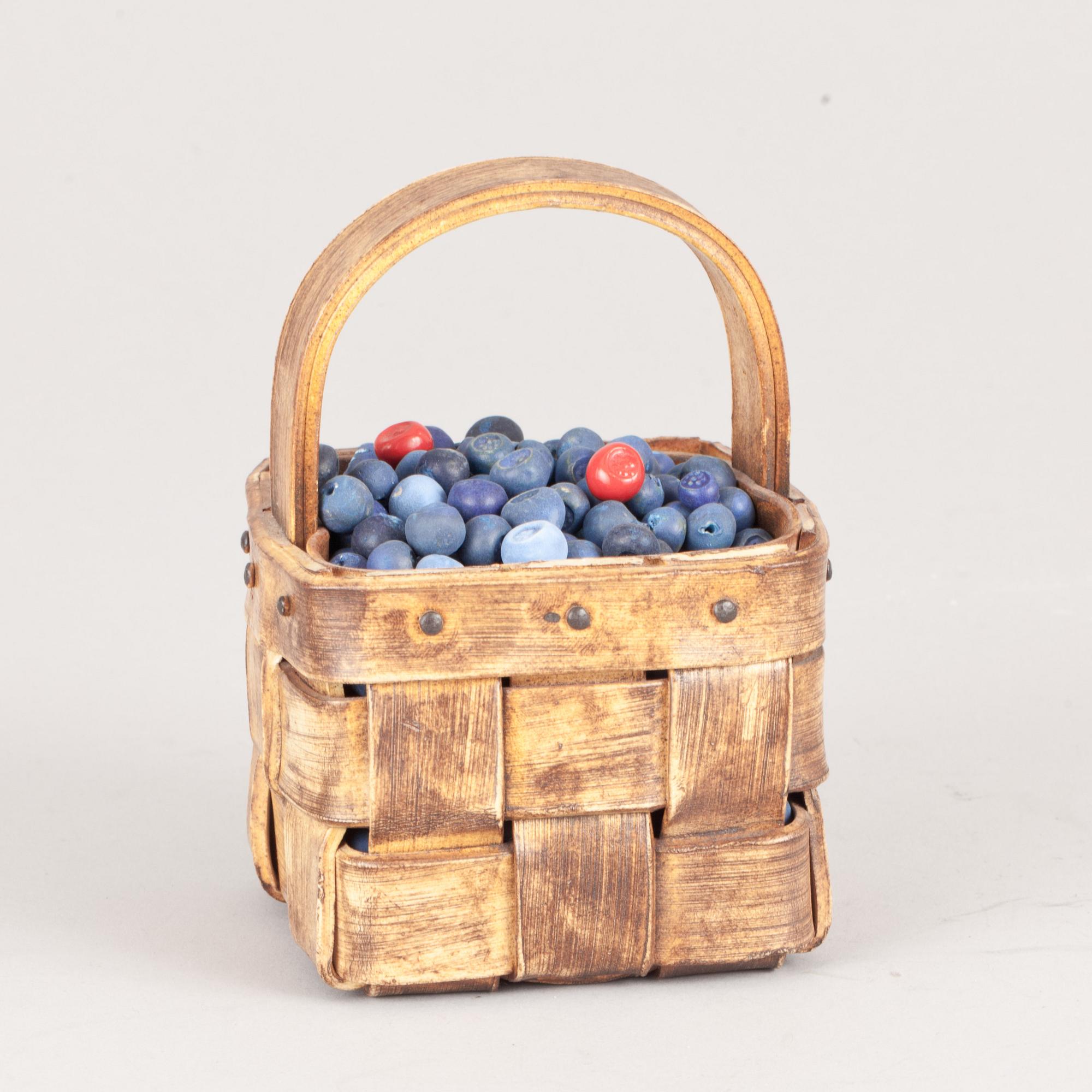 An Ingrid Herrlin stoneware blueberry basket with two lingonberries, Båstad, Sweden.