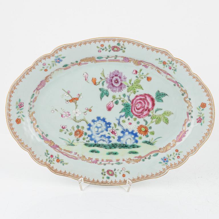 A set of three famille rose 'double peacock' dinner plates and an odd serving dish, Qing dynasty, Qianlong (1736-95).