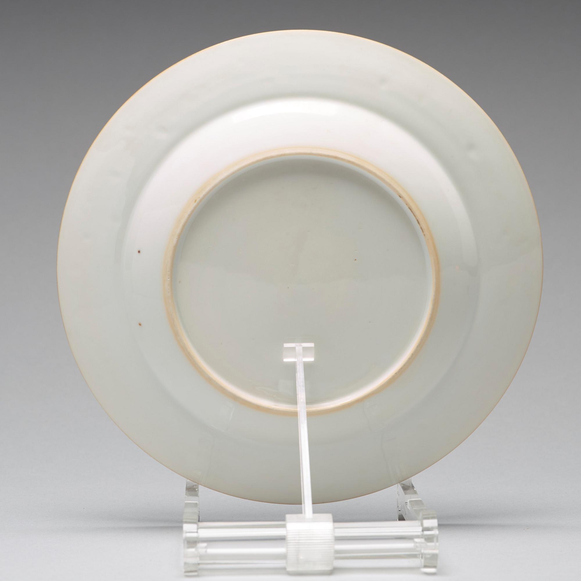 A set of four blue and white armorial dinner plates, Qing dynasty, 18th Century.