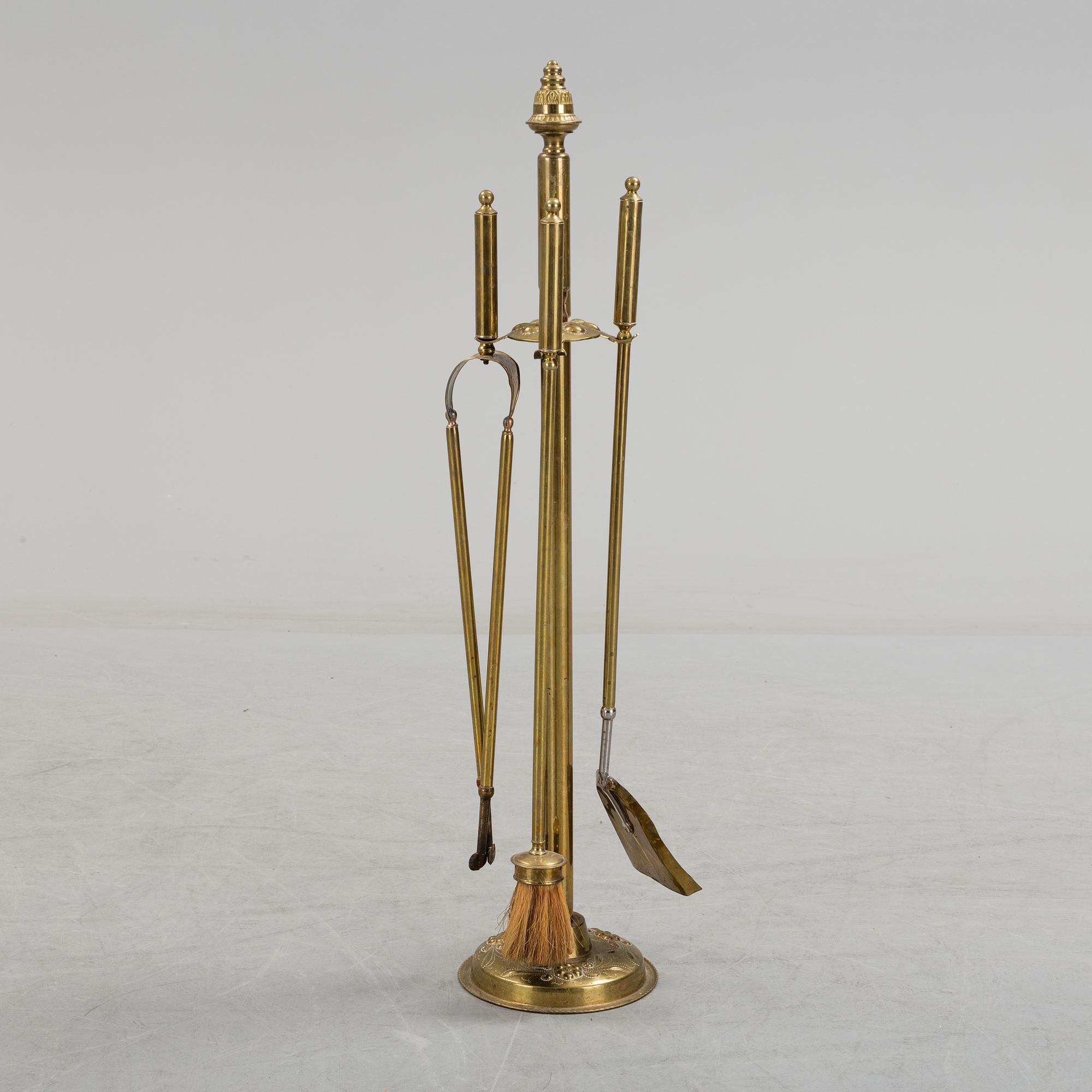 A set of 4 brass fire utensils with stand, 20th Century.