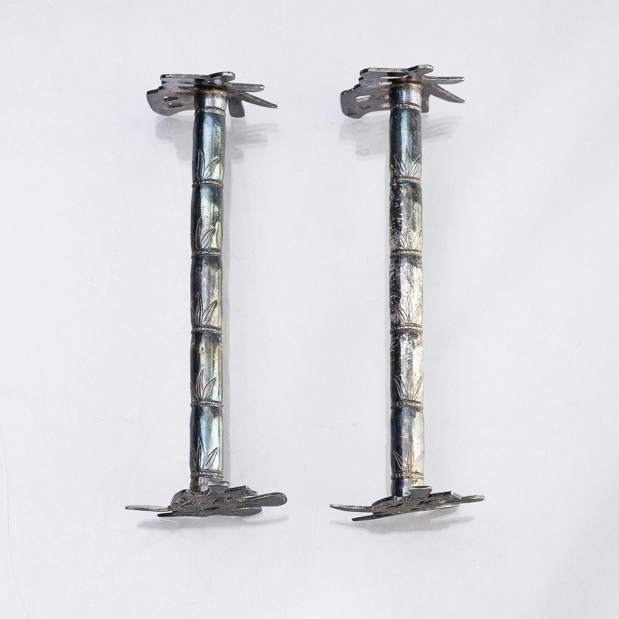 A silver bud vase, two stands for the butter knifve and a salt, China, early 20th Century.