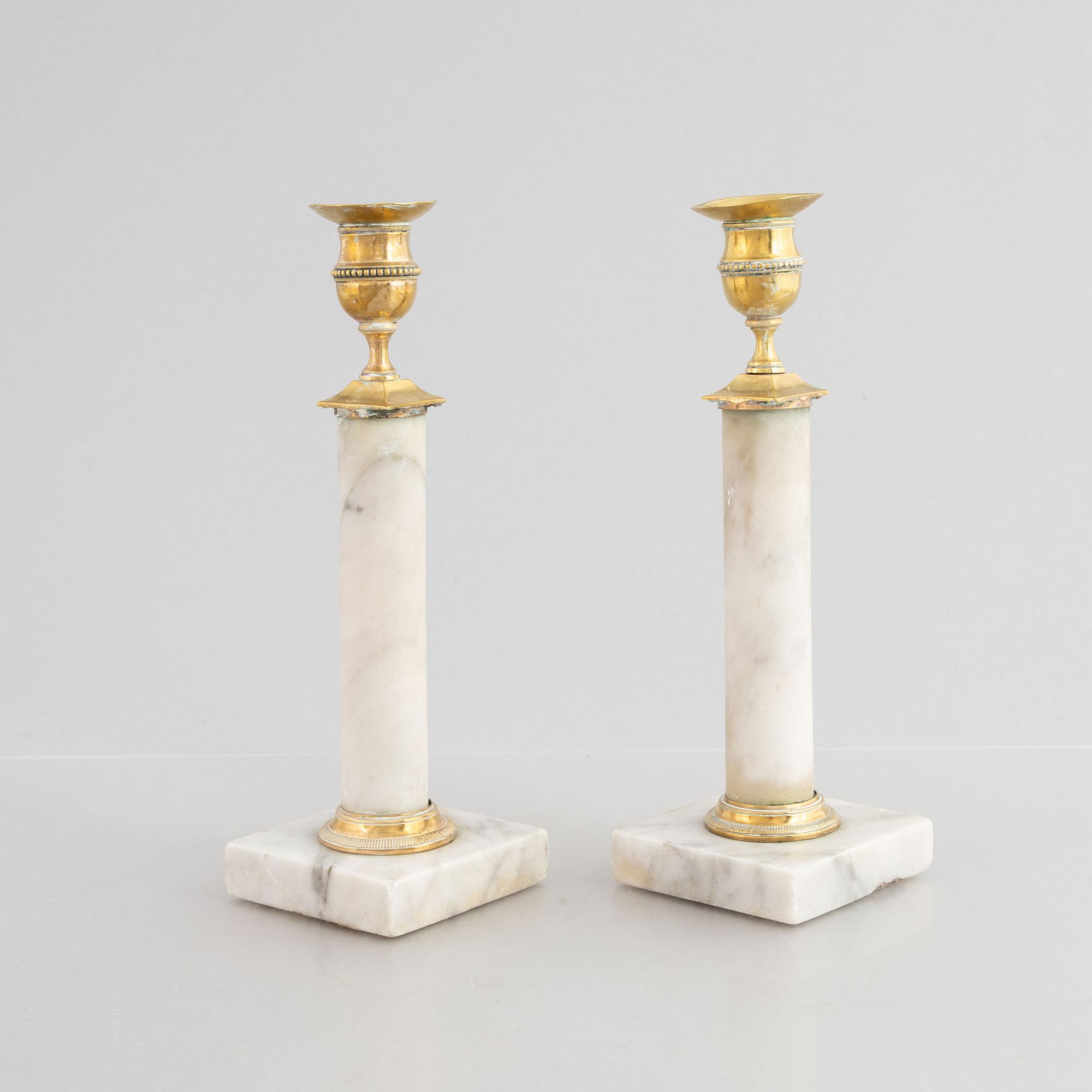 A pair of Gustavian gilt brass and marble candlesticks, late 18th century.