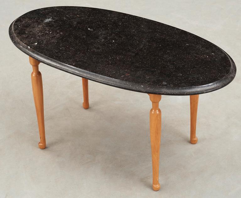 A Josef Frank black marble top table on a mahogany and walnut base, Svenskt Tenn, Sweden.