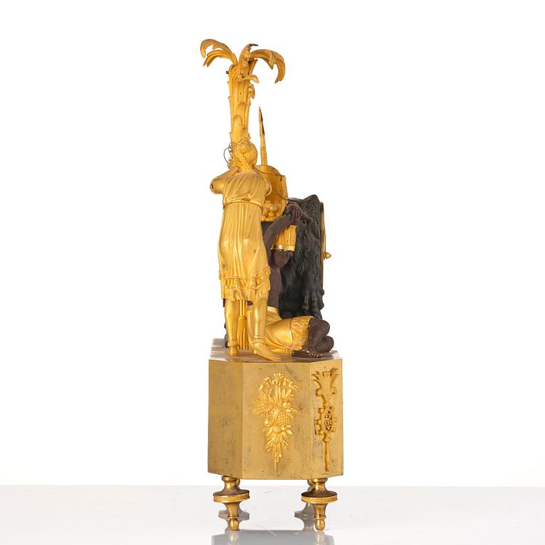 A figural Empire ormolu and patinated bronze mantel clock, early 19th century.