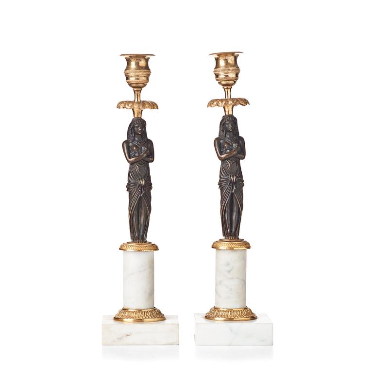 A pair of late Gustavian circa 1800 white marble and bronze candlesticks.
