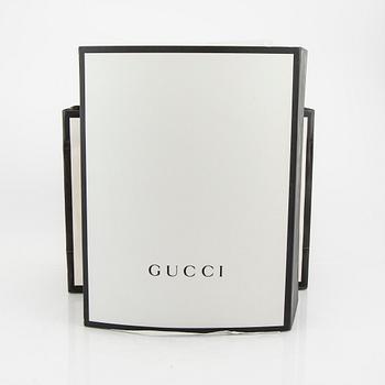 A Gucci diaper bag.