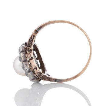 A pearl ring set with old-cut diamonds.
