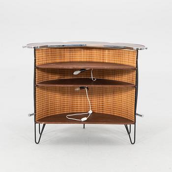 A 1970s bar and four stools.