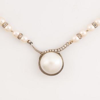 Cultured pearl necklace, clasp white gold with mabé pearl and brilliant cut diamonds, Alf Halldin,