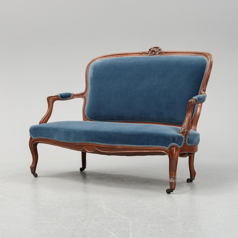 A sofa and a set of four chairs, Rococo revival, late 19th century.
