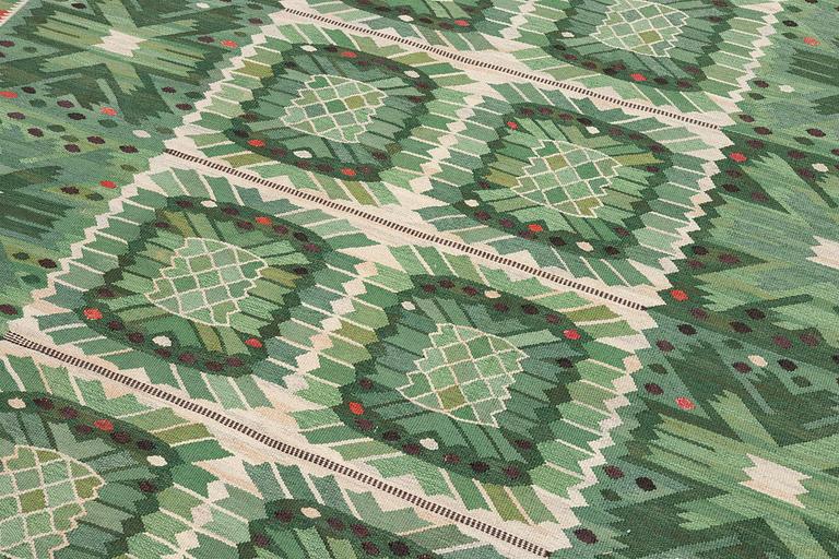 Barbro Nilsson, a carpet 'Nejlikan grön', flat weave, c. 390 x 278 cm, signed AB MMF BN.