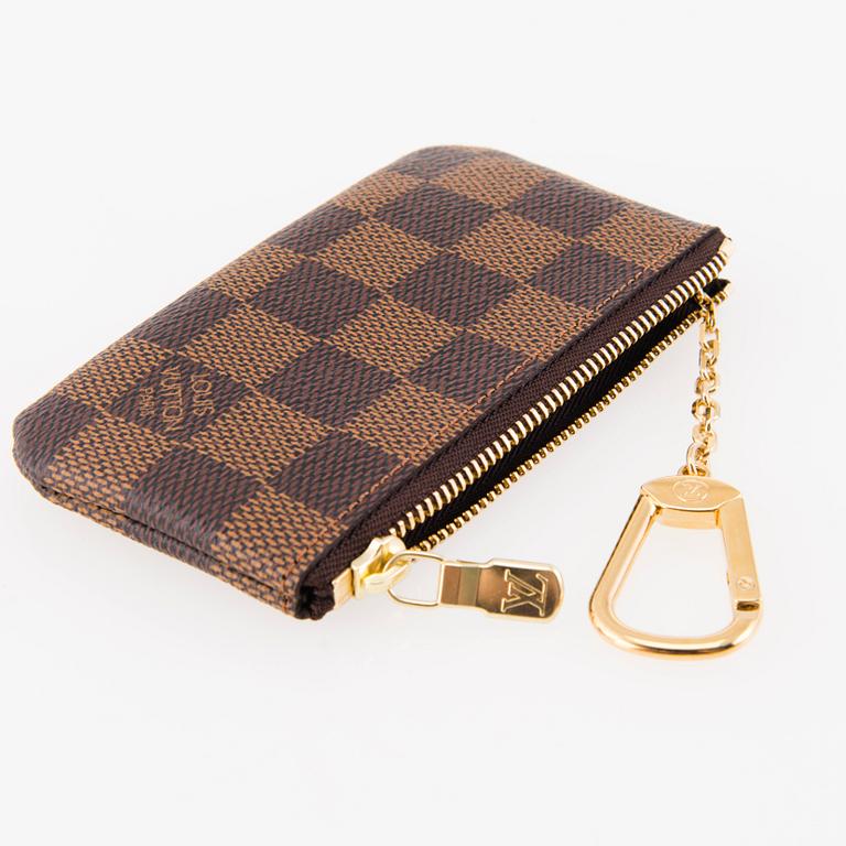 LOUIS VUITTON, Two 'Pochette Clés' key pouches, one in Monogram and the other one in Damier Ebene canvas.