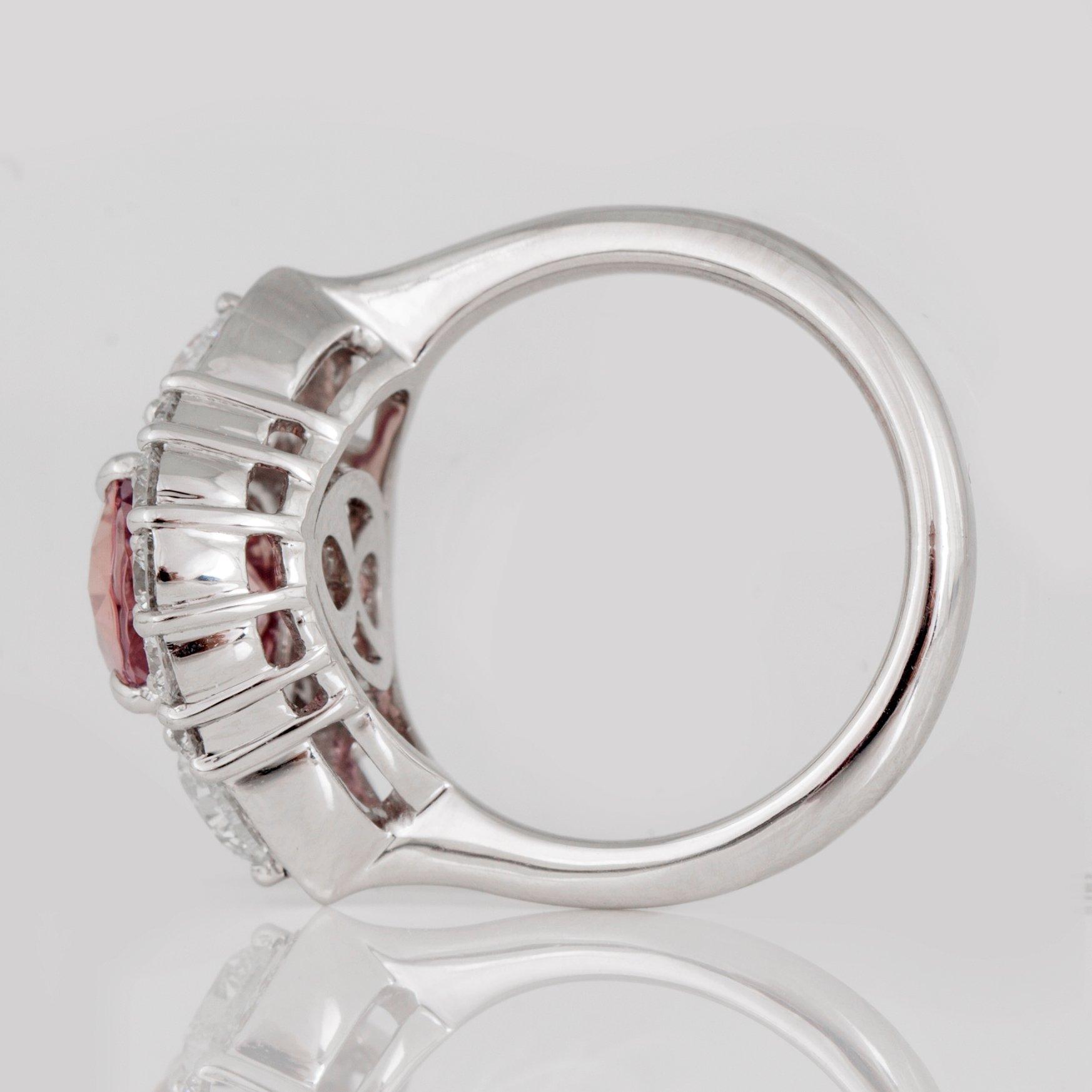An untreated padparascha (orangy pink sapphire) and diamond ring.