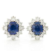 A pair of 14K gold earrings with faceted sapphires and round brilliant- and princess-cut diamonds.