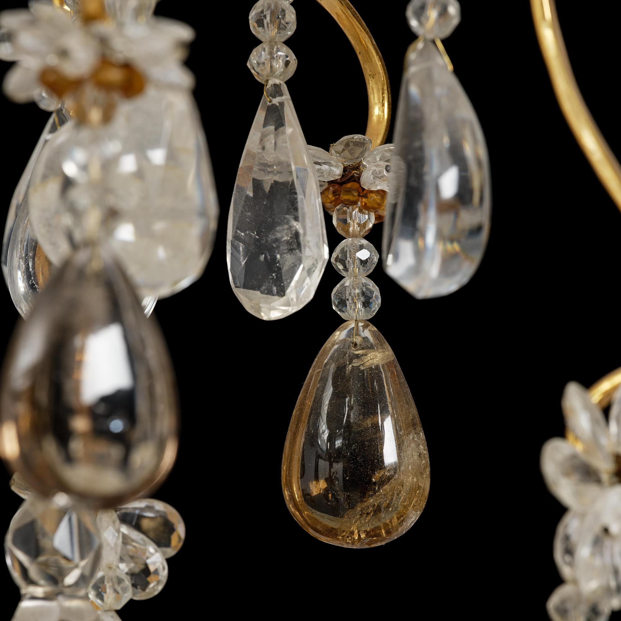 A near pair of Franch Louis-XV-style nine-branch gilt bronze and rock crystal chandeliers, later part 19th century.