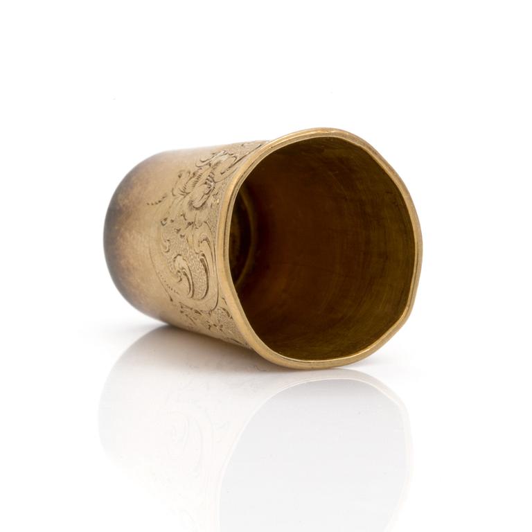 An 18K gold thimble.