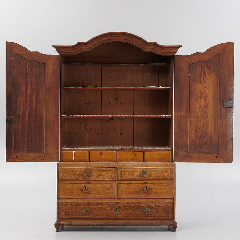 An oak rococo cabinet, mid 18th Century.