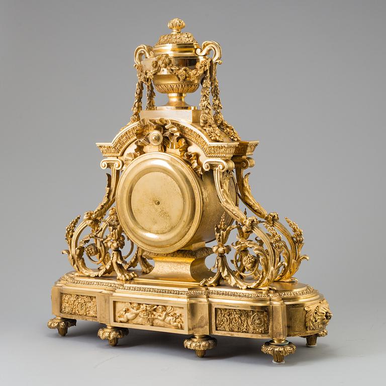 A Louis XVI-style late 19th century gilt bronze mantel clock.