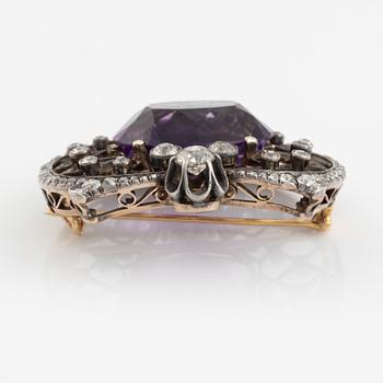 A brooch set with an amethyst and old-cut diamonds.