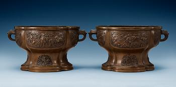 1703. A pair of lobed bronze flower pots, Qing dynasty, with Xuandes six character mark to the interior.