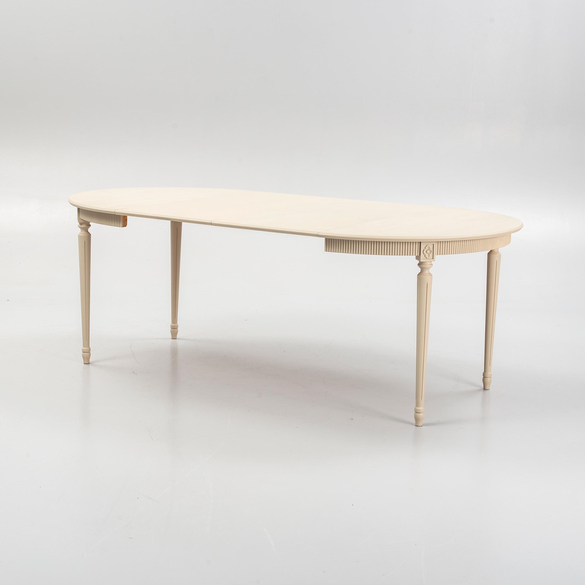 A Gustavian style dining table and eight chairs, late 20th Century.