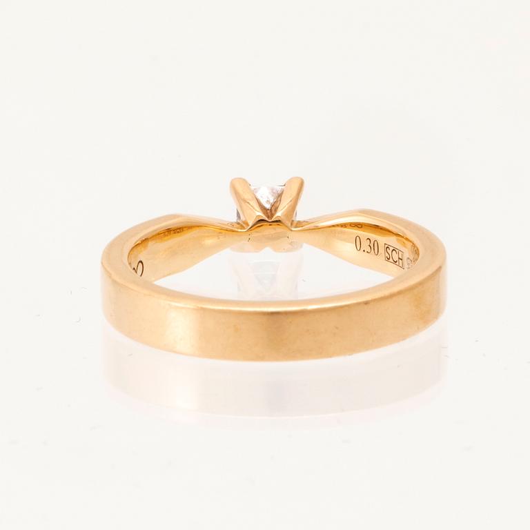 An 18K gold solitaire ring "Maui" set with a princess-cut diamond by Schalins.