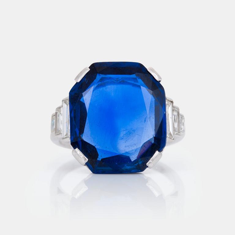 An unheated 11.27 ct Ceylon sapphire and baguette-cut diamond ring. Total carat weight of diamonds 0.70 cts.