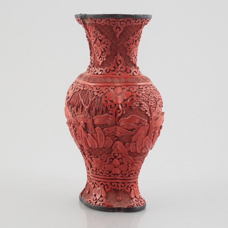 A red laquer vase, early 20th century.
