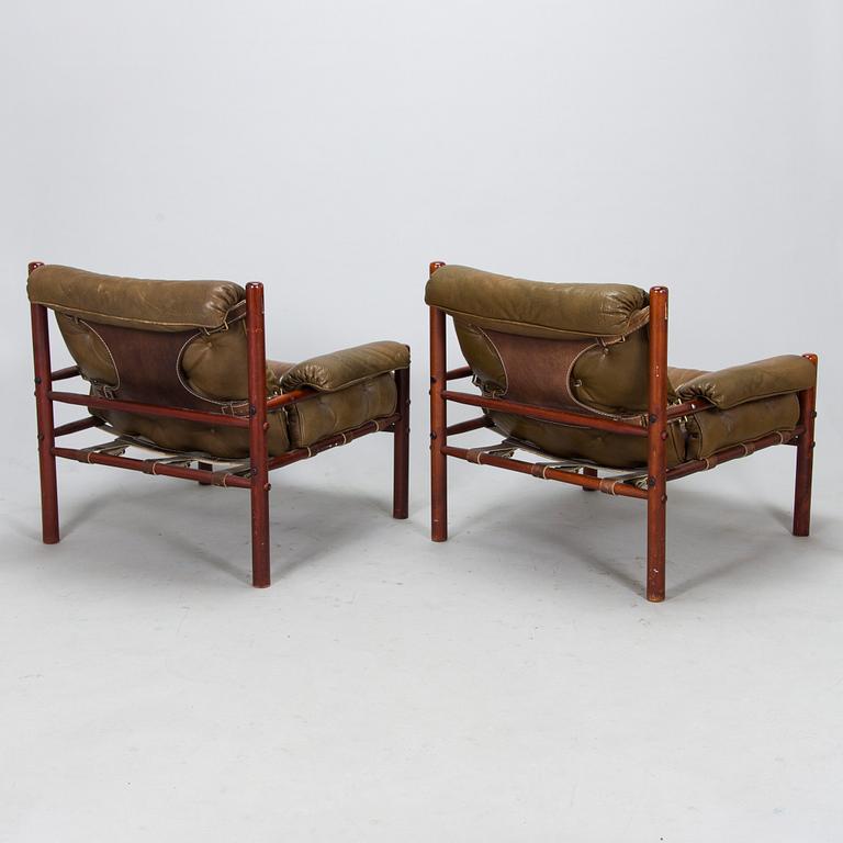 A pair of leather armchairs, 1970s.