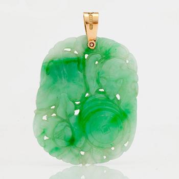 A carved jadeite pendant and earrings.