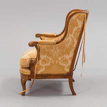 A Rococo style wing chair, first half of teh 20th Century.