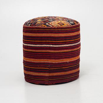 A Kelim covered stool.