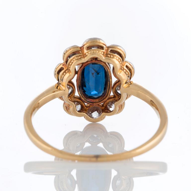 A sapphire ring in platinum and 18K gold set with old-cut diamonds.