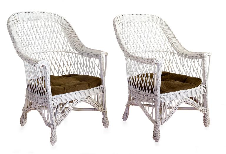 A  PAIR OF WHITE WICKER ARMCHAIRS,