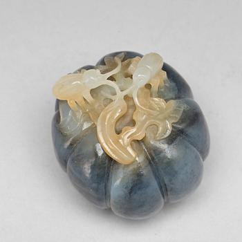 A Chinese nephrite sculpture of insects on a fruit.