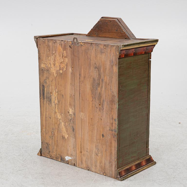 A hanging cabinet, dated 1832.