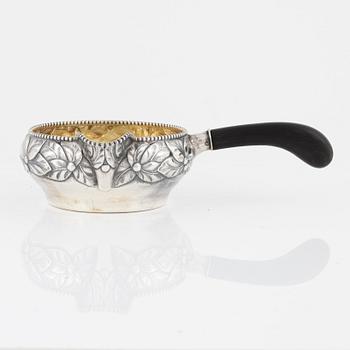 A parcel.gilt sauce dish with handle, Denmark, 1919.