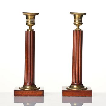 A pair of late Gustavian mahogany and gilt-brass candlesticks, late 18th century.
