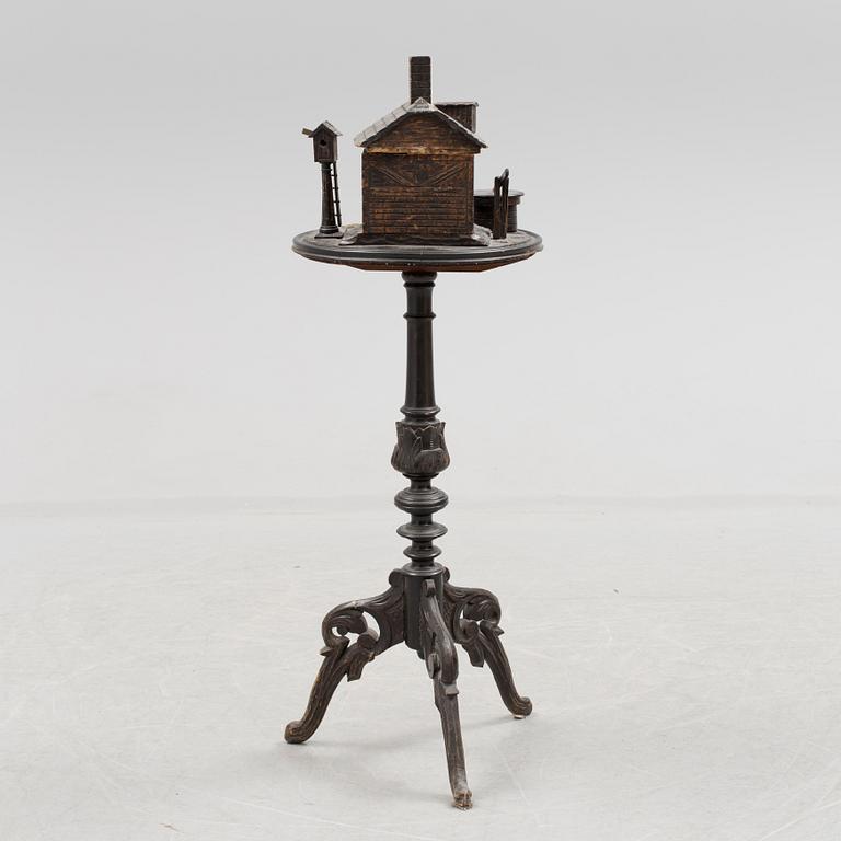 A late 19th century carved smoking table.