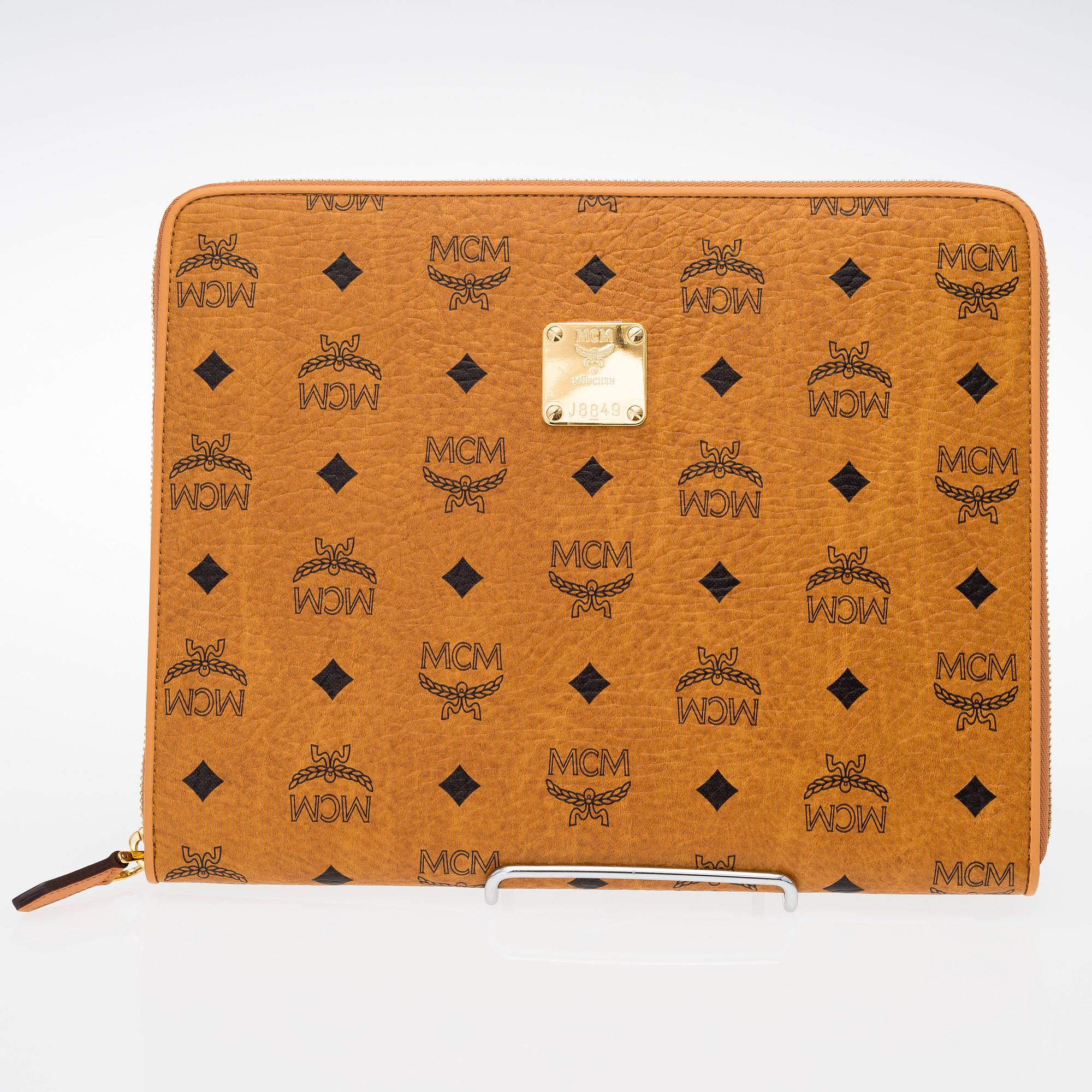 An MCM Heritage iPad and card case in leather. Bukowskis