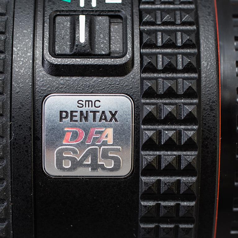 A black body medium format Pentax 645D camera with a SMC Pentax-D FA 645 55mm F2.8 AL [IF] SDM AW lens.