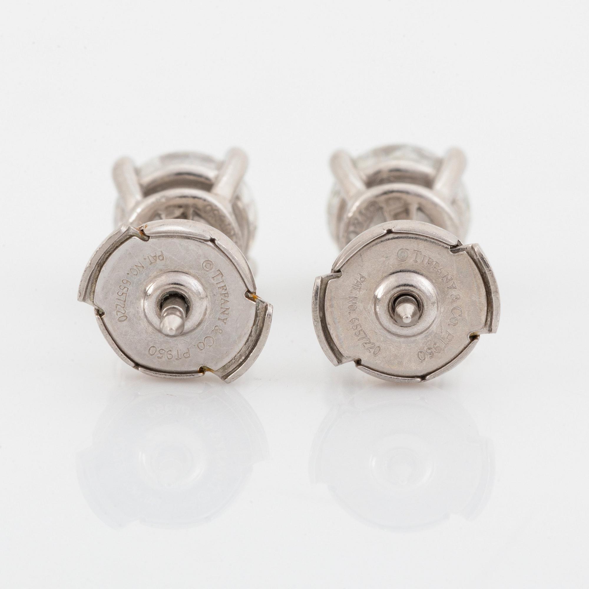 A pair of Tiffany solitaire diamond stud earrings in platinum.