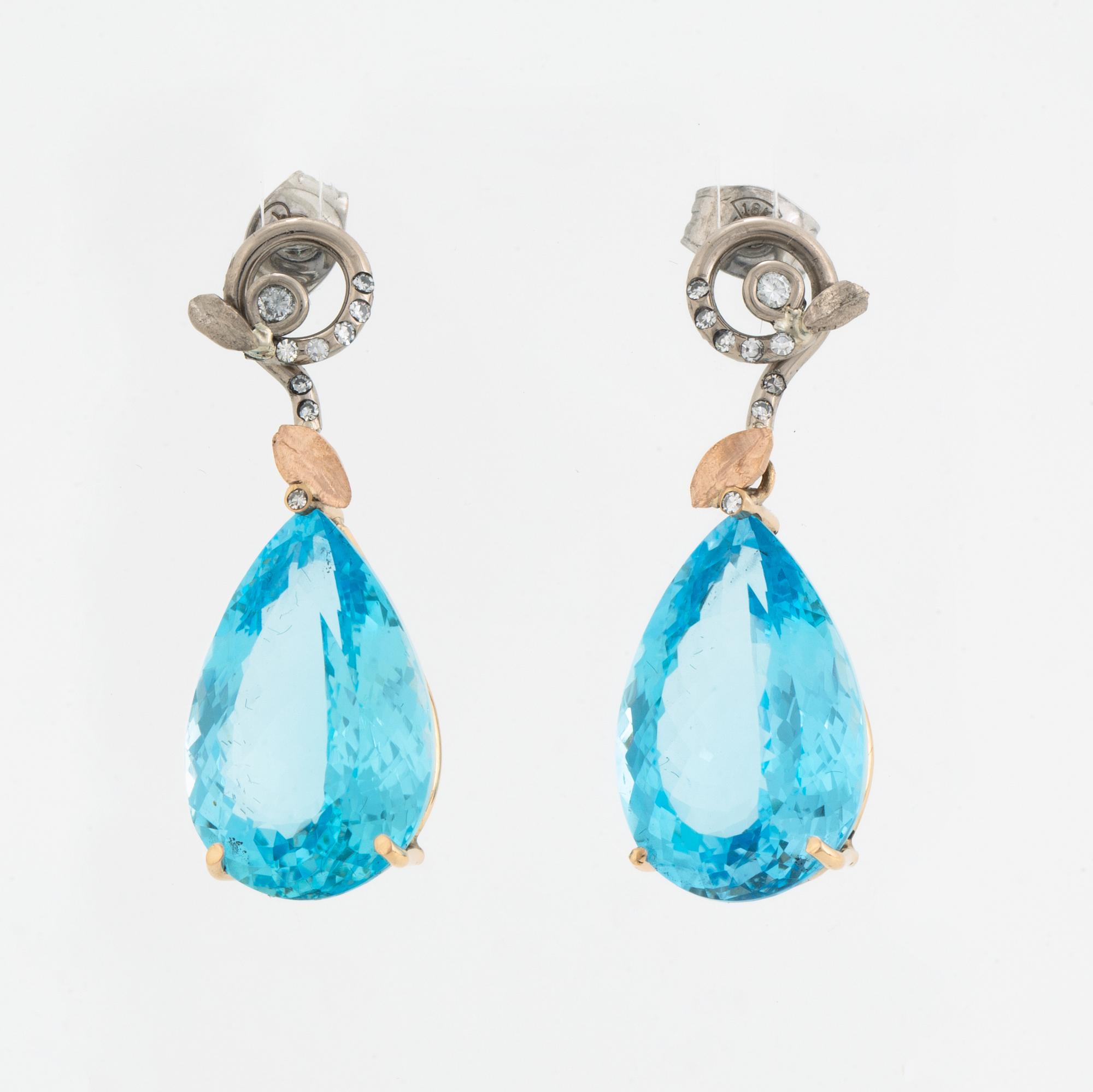Drop shaped blue topaz and diamond earrings.