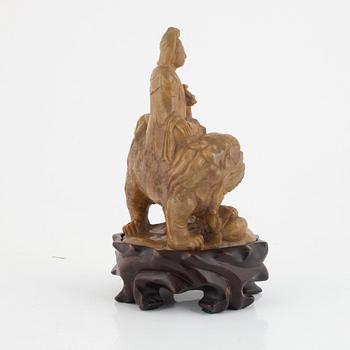 A soapstone guanyin with wooden stand, China, late Qing dynasty/early 20th century.